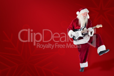 Composite image of santa claus has fun with a guitar