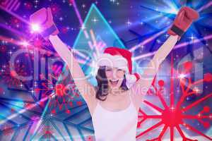 Composite image of festive brunette in boxing gloves cheering