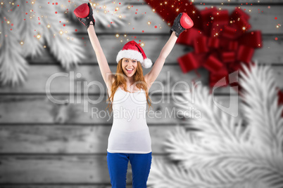 Composite image of festive redhead cheering with boxing gloves