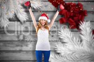 Composite image of festive redhead cheering with boxing gloves