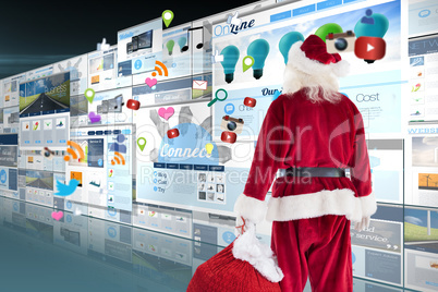 Composite image of santa carrying sack of gifts