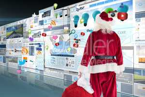 Composite image of santa carrying sack of gifts