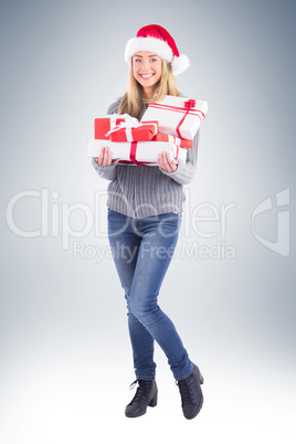 Festive blonde holding pile of gifts