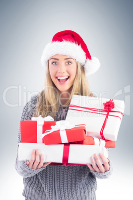 Festive blonde holding pile of gifts