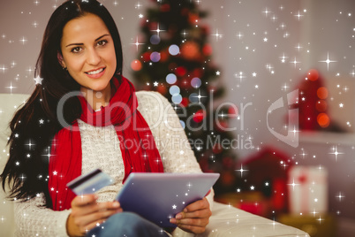 Composite image of pretty brunette shopping online on sofa at ch