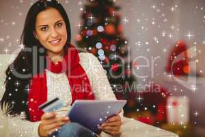 Composite image of pretty brunette shopping online on sofa at ch
