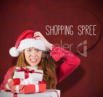 Festive stressed redhead holding gifts