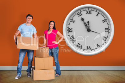 Composite image of young couple with moving boxes