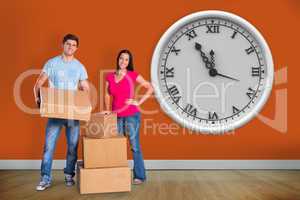 Composite image of young couple with moving boxes