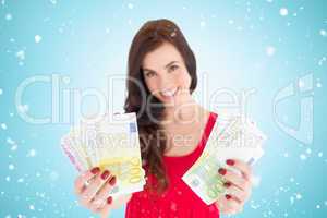 Composite image of cheerful brunette showing her cash money