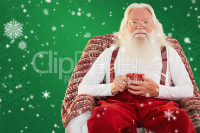 Composite image of father christmas sitting on the armchair hold