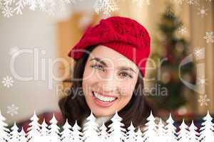 Composite image of portrait of a smiling brunette in hat at chri