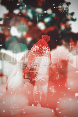 Composite image of festive little girl in hat and scarf