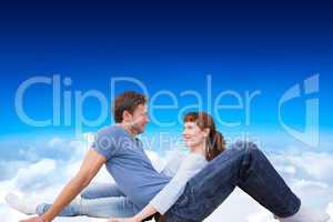 Composite image of couple sitting on the floor