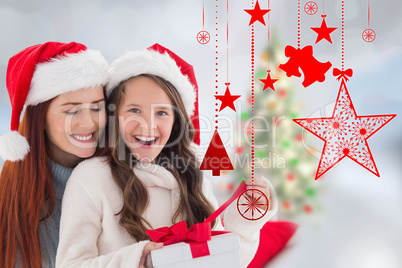 Composite image of mother and daughter opening gift