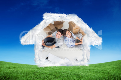 Composite image of overview of a happy couple sitting back-to-ba
