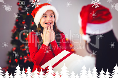 Composite image of mother giving her daughter a christmas presen