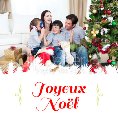 Composite image of happy family playing with christmas gifts