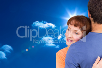 Composite image of happy couple hugging one another