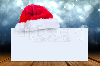 Composite image of santa hat on poster