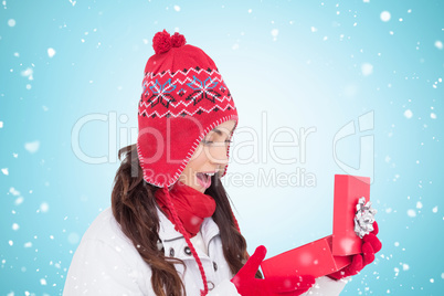 Composite image of happy brown hair opening christmas gift