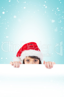 Festive brunette holding a poster