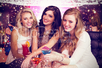 Composite image of friends drinking cocktails