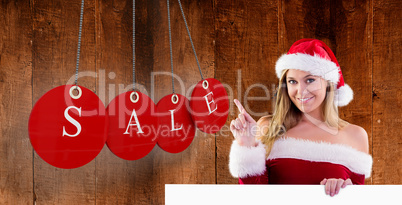 Composite image of festive blonde smiling and pointing