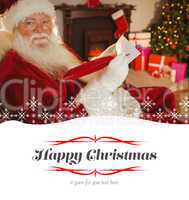 Composite image of smiling santa writing list with a quill