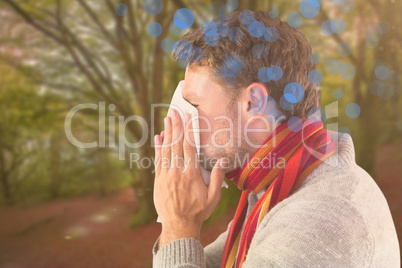 Composite image of man blowing nose on tissue