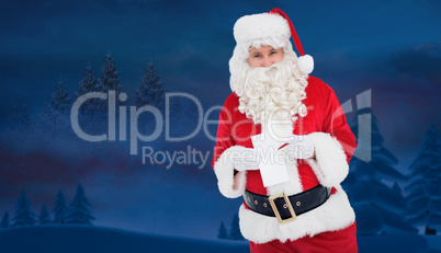 Composite image of happy santa holding paper and pen