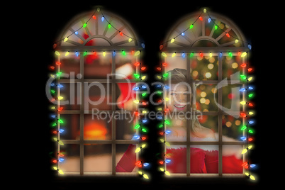 Composite image of pretty girl smiling in santa outfit