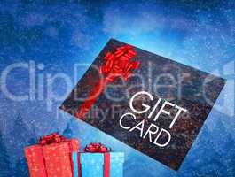 Composite image of flying gift card and presents