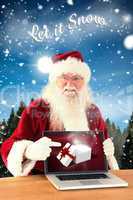 Composite image of happy santa showing laptop screen