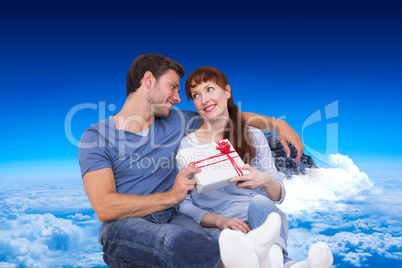 Composite image of couple sitting on floor together