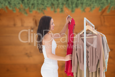 Composite image of woman choosing clothes