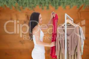 Composite image of woman choosing clothes