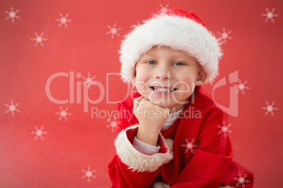 Composite image of cute little boy in santa costume