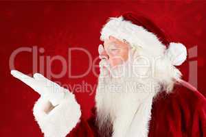 Composite image of santa claus blowing