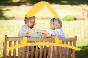 Composite image of happy retired couple sitting on the bench
