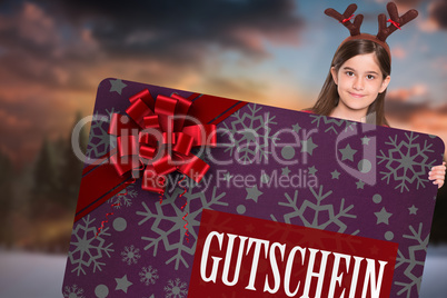 Composite image of festive little girl showing card