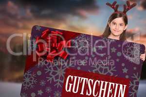 Composite image of festive little girl showing card