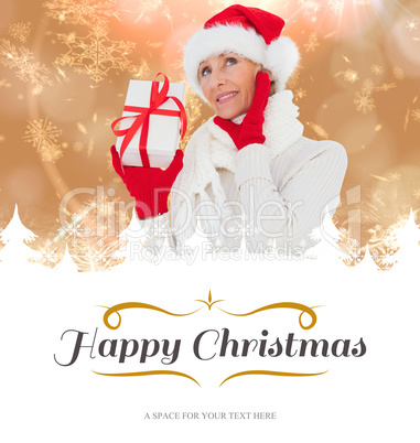 Composite image of festive woman holding gift