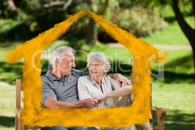 Composite image of senior couple sitting on a bench