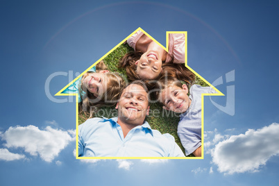 Composite image of happy family lying on the grass in a circle