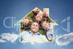 Composite image of happy family lying on the grass in a circle