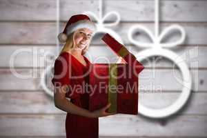 Composite image of festive blonde opening a gift