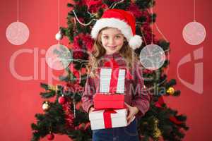 Composite image of festive little girl holding gifts