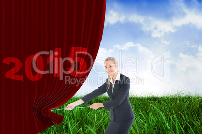 Composite image of businesswoman pulling a rope