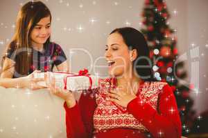 Composite image of daughter giving her mother a christmas presen